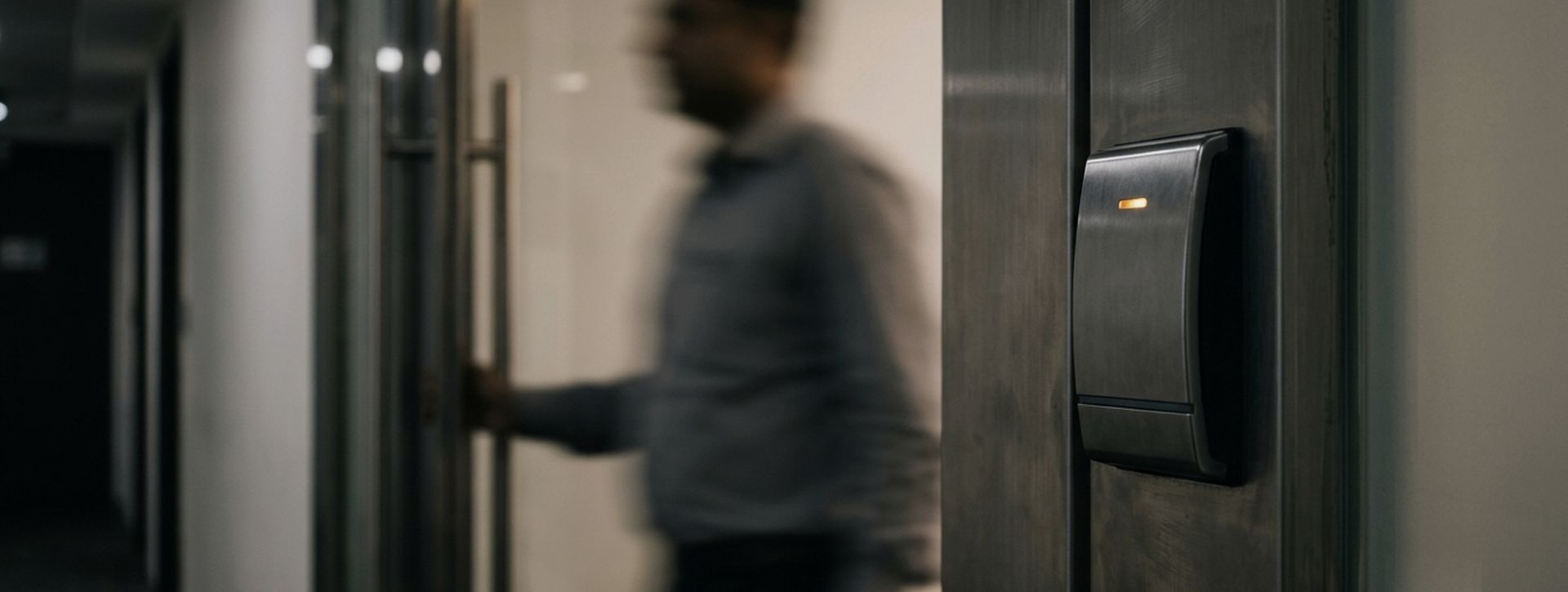 Card reader beside an office door with a person passing through