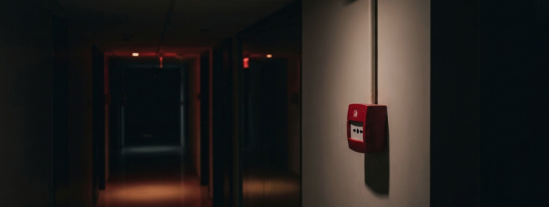 Fire alarm call point and smoke detector in a corridor with emergency lighting