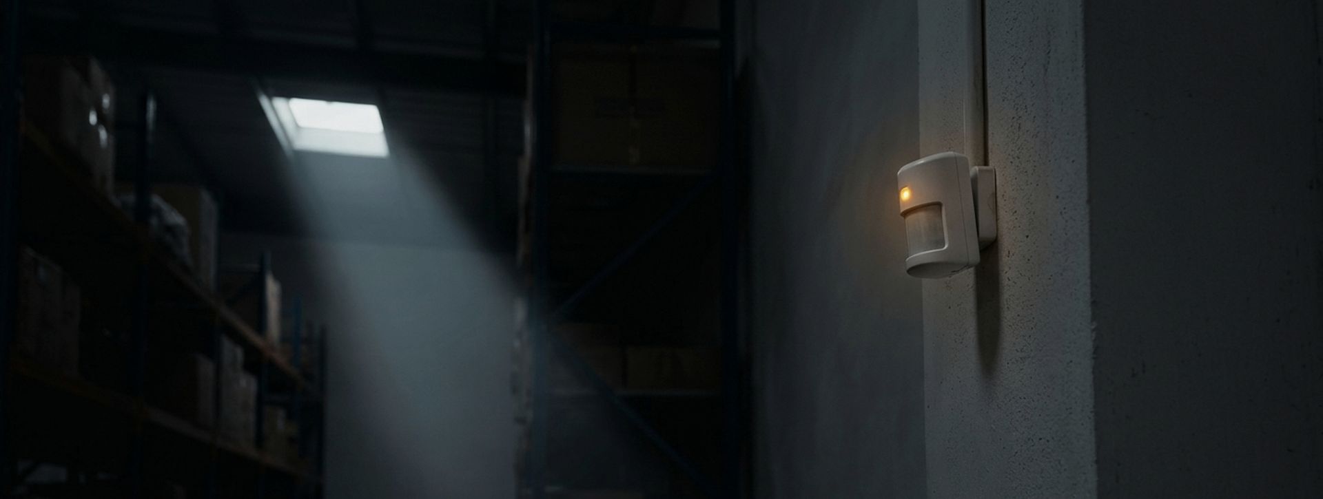 Motion sensor on a warehouse wall at night